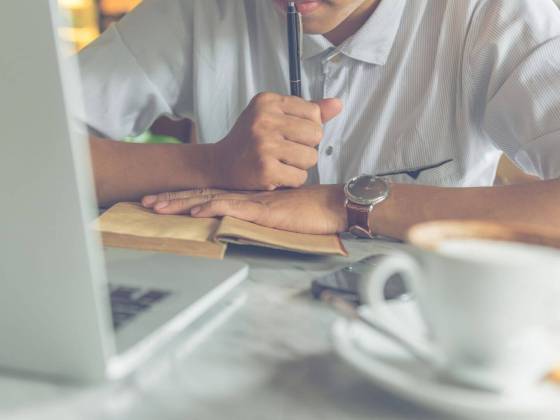 young writer thinking at laptop