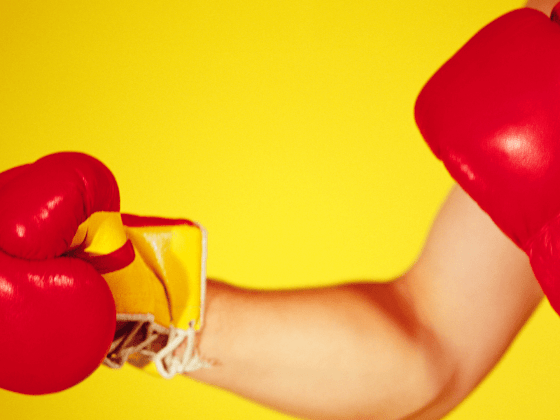 Man's arm punching, wearing punching gloves