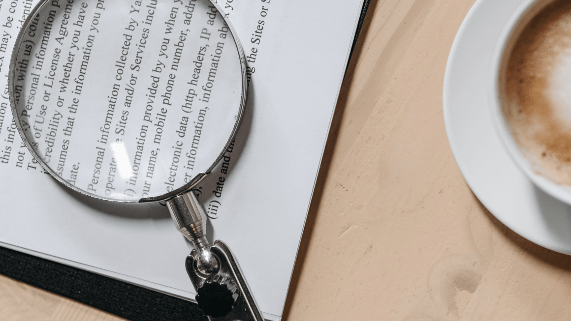 Magnifying glass on top of a printed book or essay