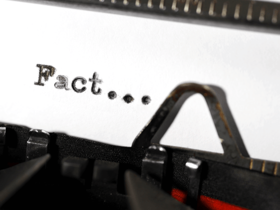 Close-up of the word 'Fact' written on a typewriter.