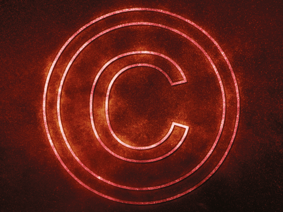 Red glowing copyright mark on dark background