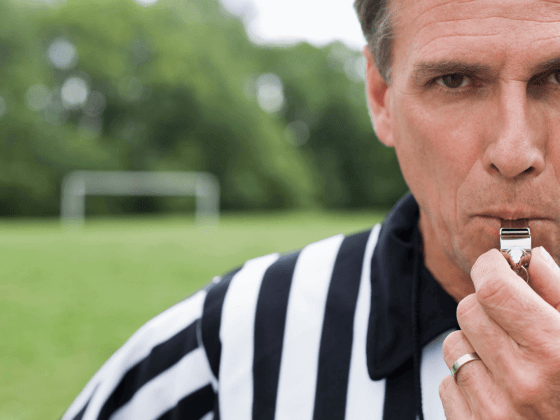 Referee blowing a whistle