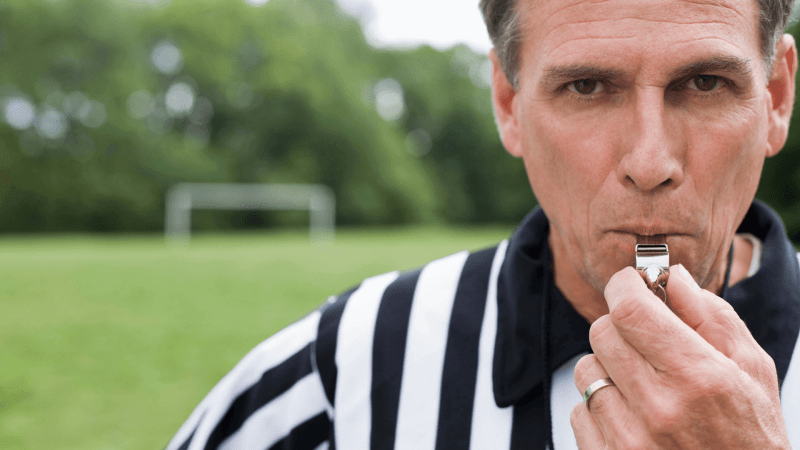 Referee blowing a whistle