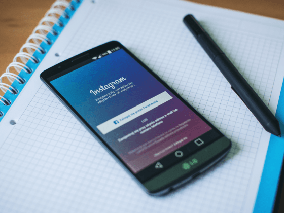 Smart phone showing Instagram log-in screen laying on a notebook