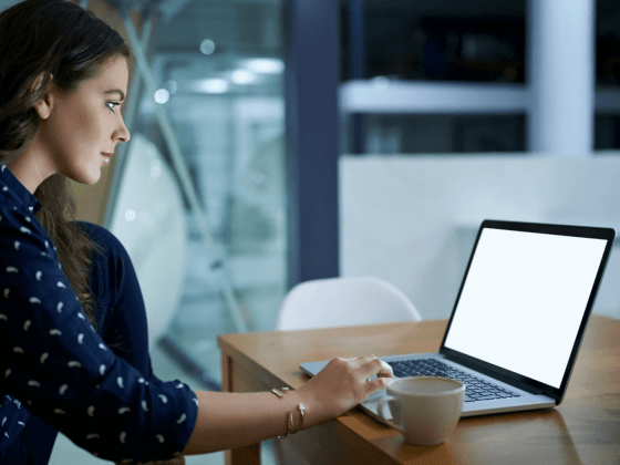 Woman sitting at a desk using a laptop.